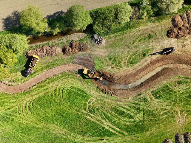 Aerial view of construction of meanders at Starston Beck, showing Excavators and dumpers at work in April 2025