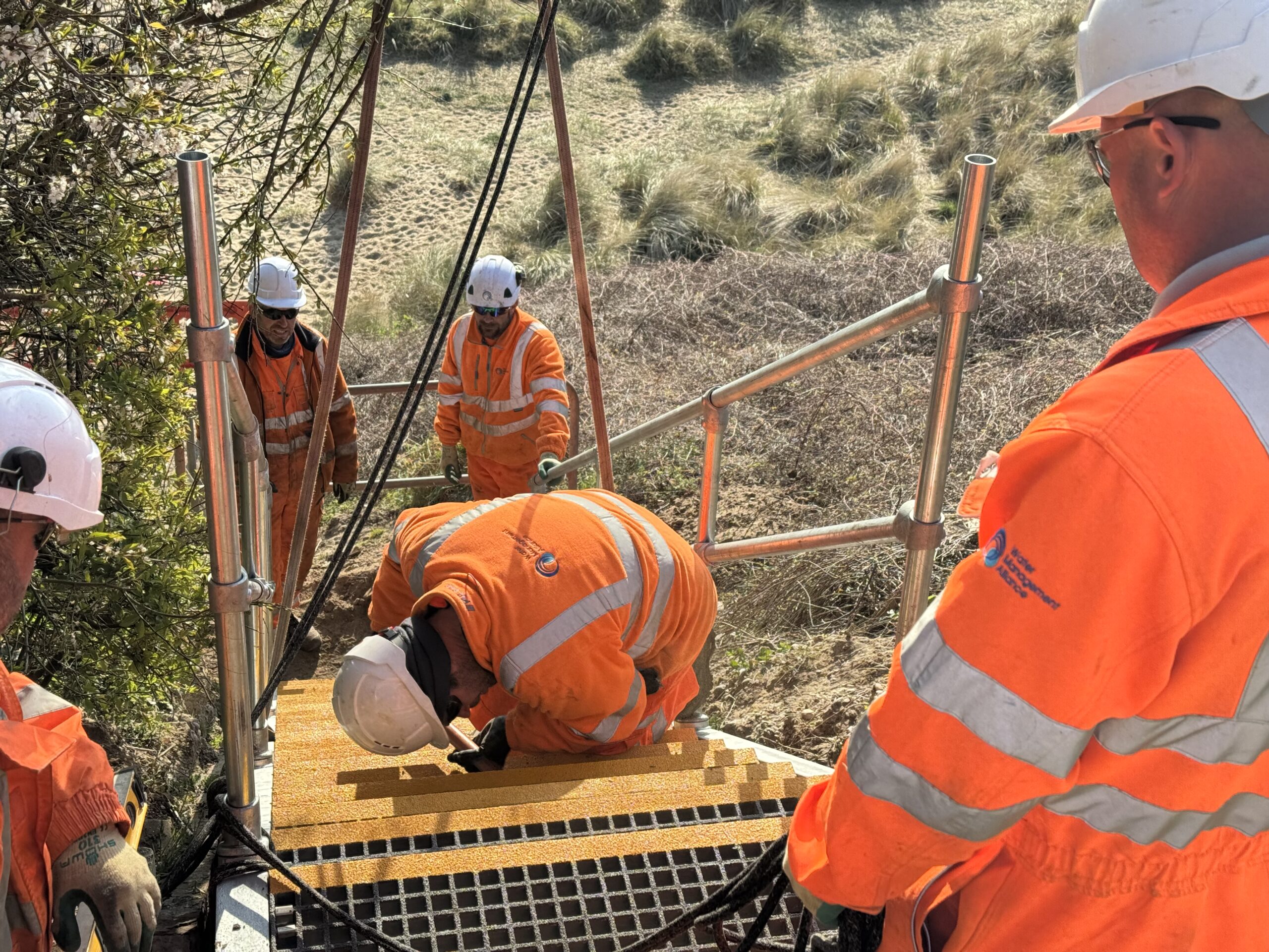 Coastal Engineering Team working with a crane to get the new Kessingland Steps into place
