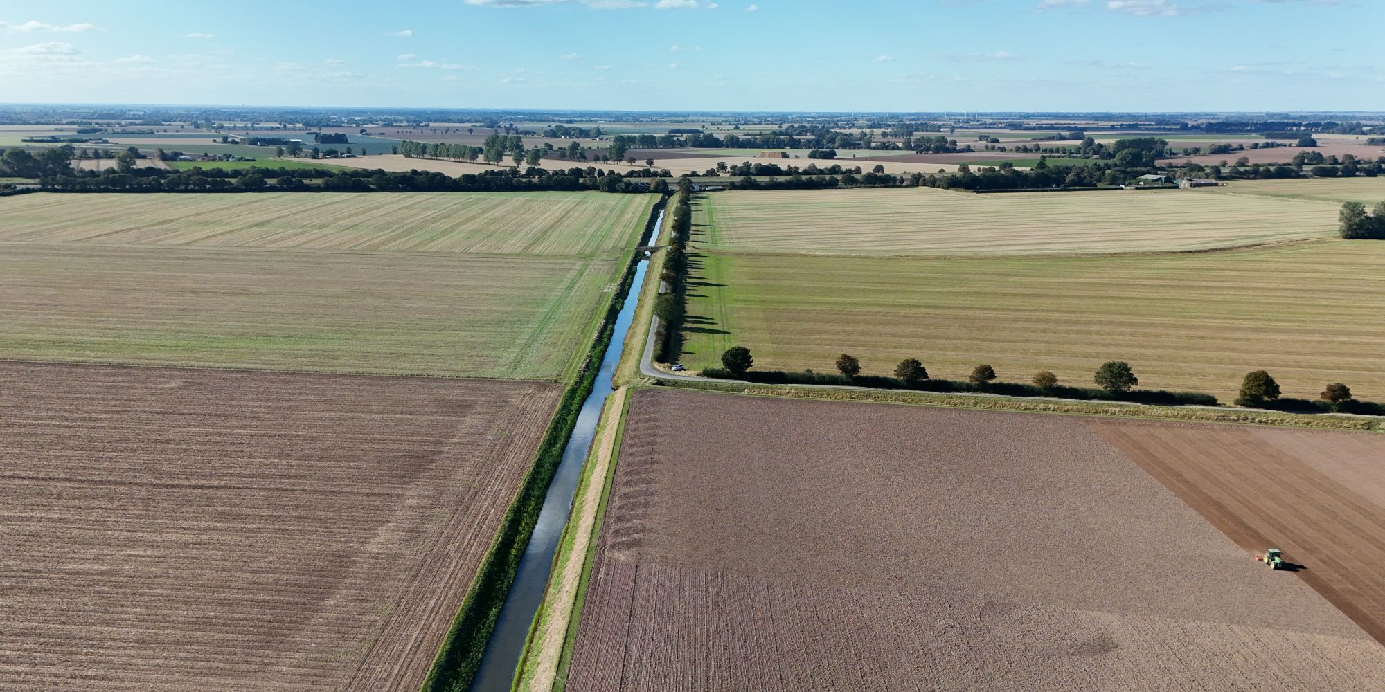 Panoramic landscape showing Wingland Sluice Drain and arable land being cultivated following harvest in September 2025
