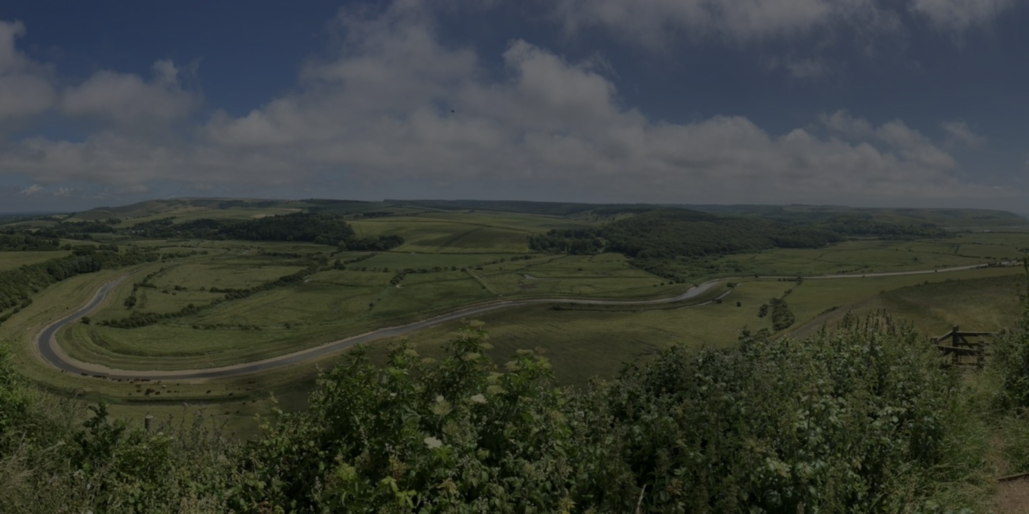 Panoramic of the River Cuckmere valley - darkened for text to show over the top