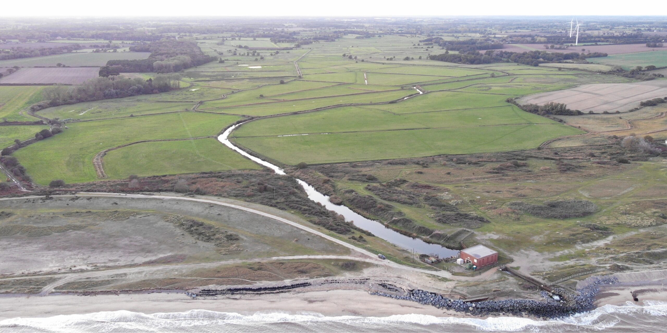 Panoramic aerial view of EA pumping station on coast with Benacre and Kessingland Valley behind Oct 2025