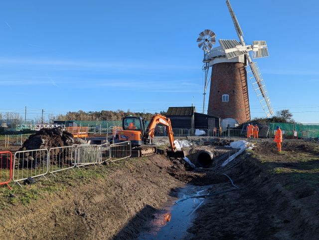 The Outfall Culvert at Horsey, with the old windpump in the background and excavator working on the channel bank