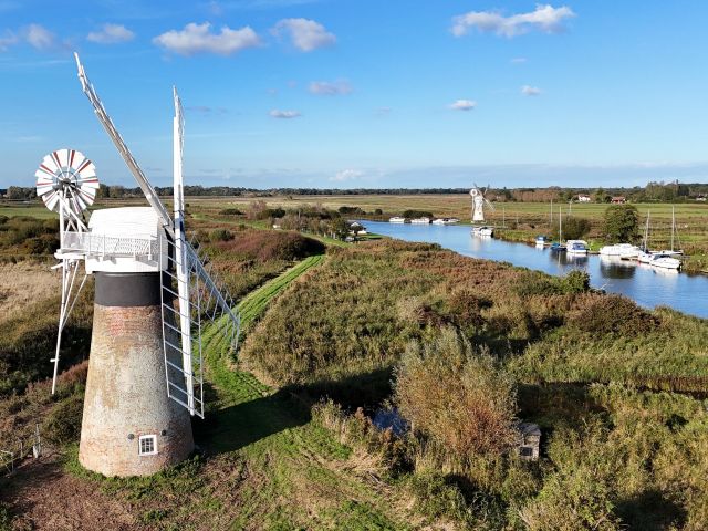 Aerial image of St Benets WindPump with the river in the backgound, the banks lines with pleasure boats and another windpump in the distance Nov24